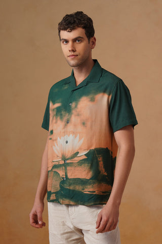 Man wearing a shirt with a nature print against a beige background